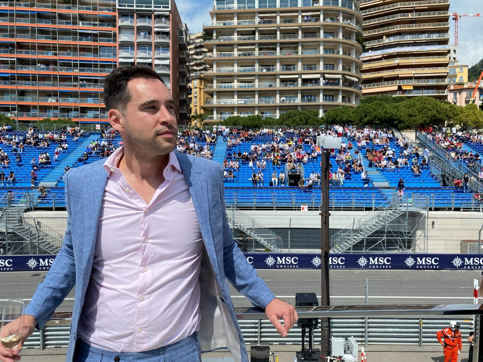 Kyle Cannon beside the Monaco Grand Prix circuit, the grandstands opposite filling the frame behind him