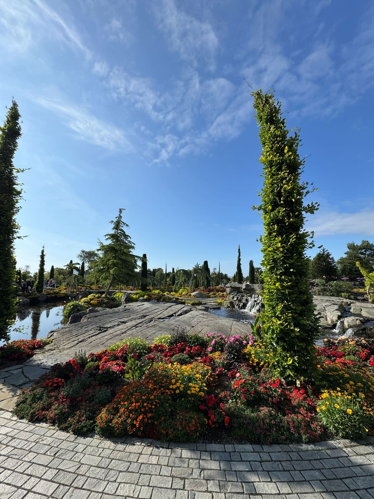 Subtropical planting and clipped lawns running down to the fjord at Flor & Fjære