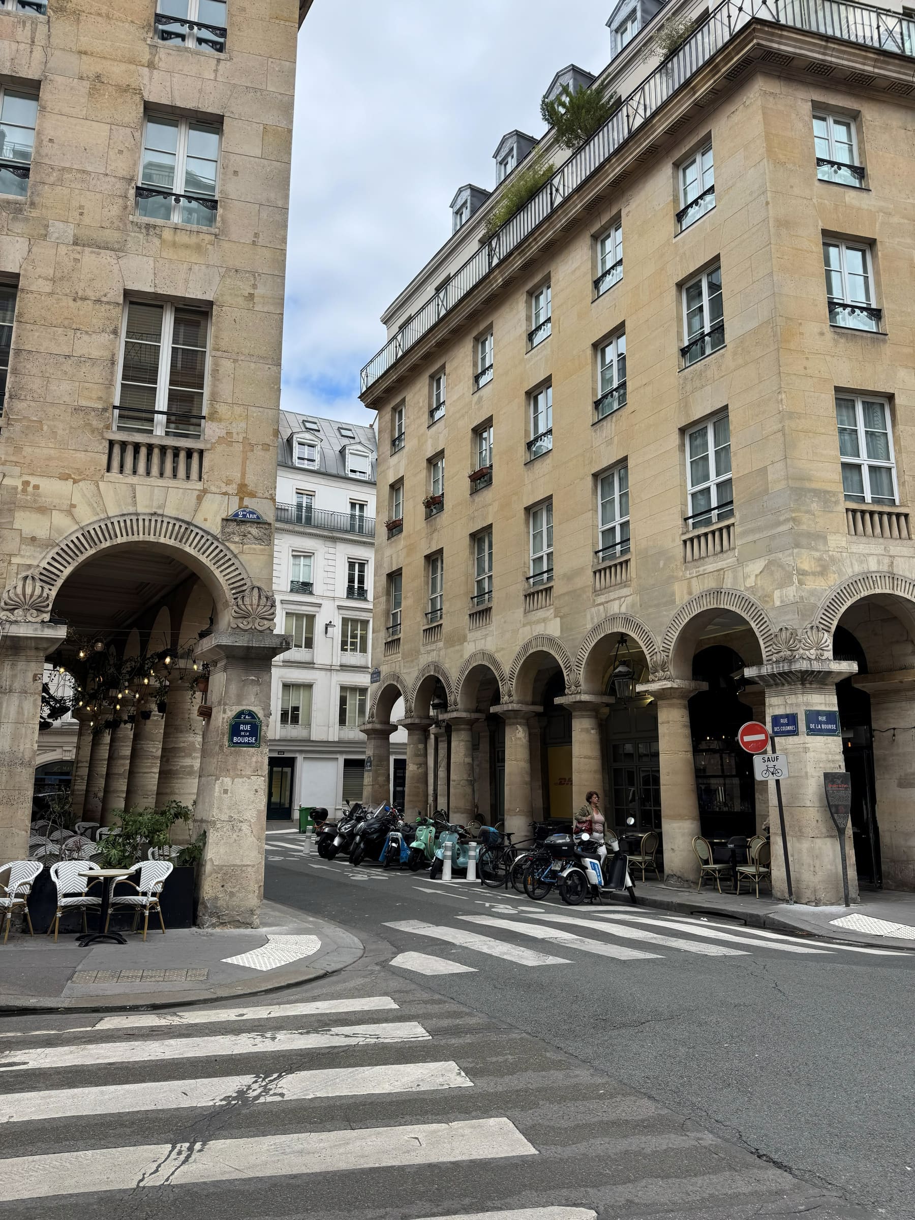 Arcaded Haussmann buildings on a quiet Paris street