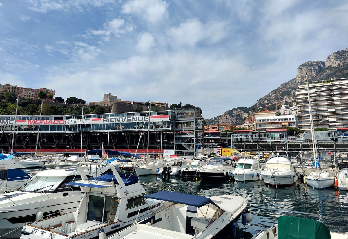 Temporary grandstands along the Monaco harbour front behind moored boats in Grand Prix week