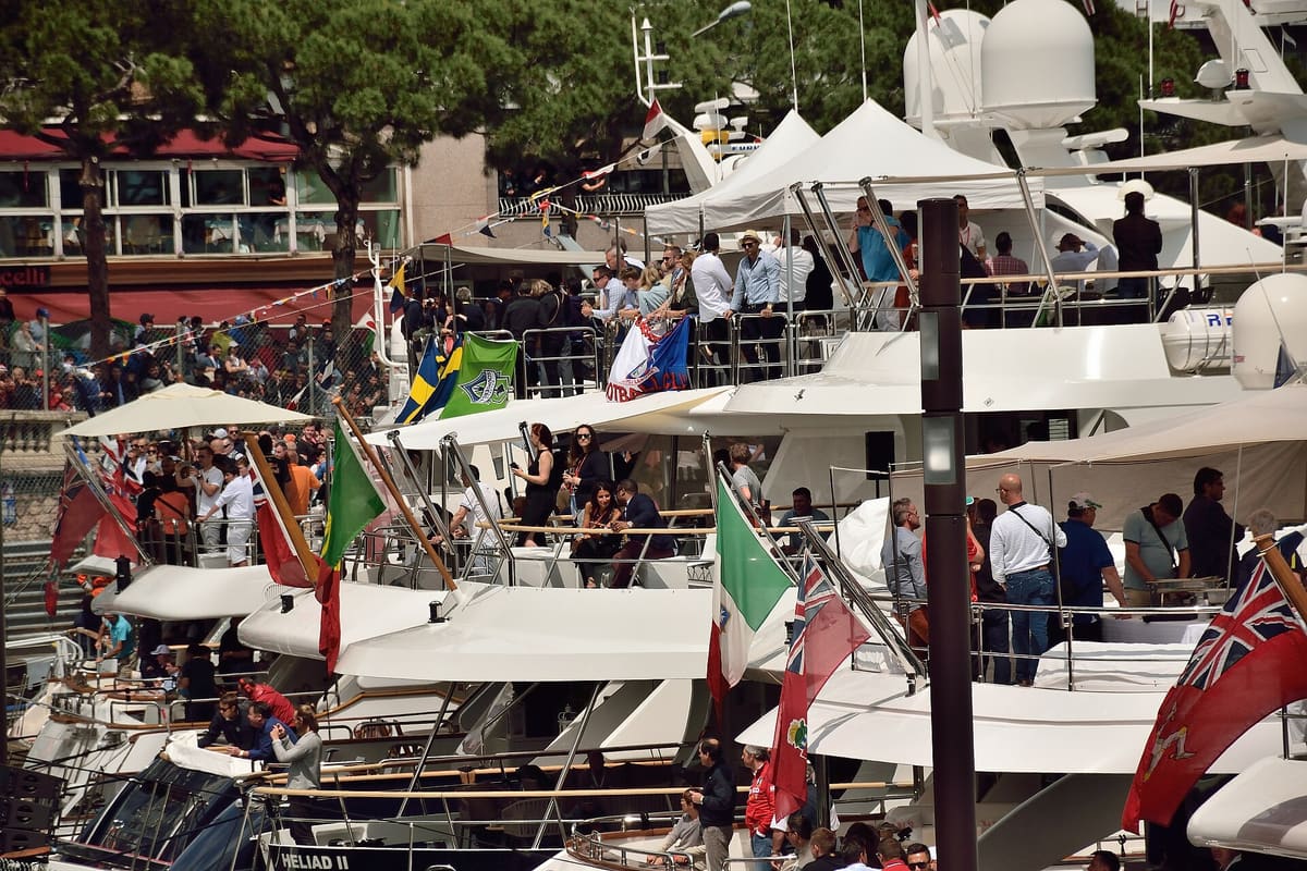 Guests on the decks of yachts moored side by side in Monaco harbour on Grand Prix race day